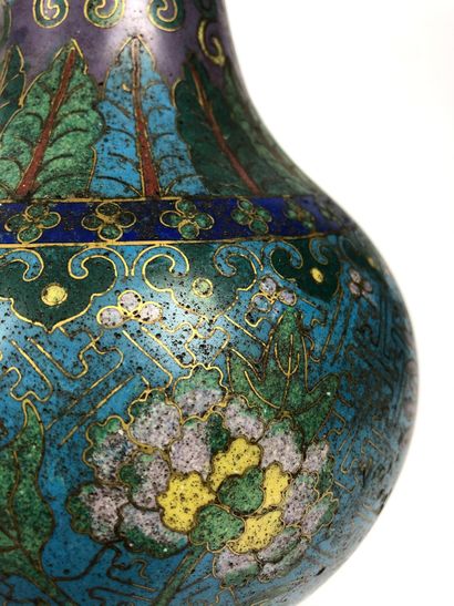  A Chinese cloisonné bronze bottle vase with a long narrow neck and a turquoise background...
