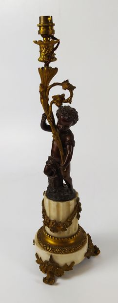 null CANDELABER mounted as a lamp decorated with a cherub in patinated bronze on...