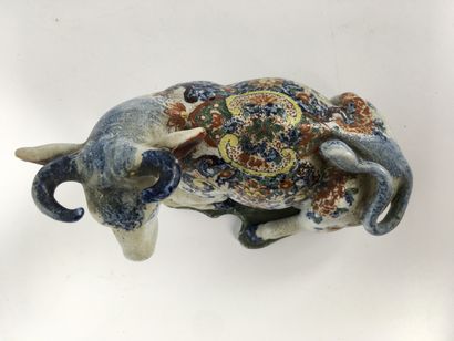 null DELFT (Kind of) Earthenware figurine representing a cow lying on a mound decorated...