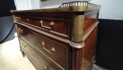 null A mahogany veneered chest of drawers opening in front with three drawers moulded...