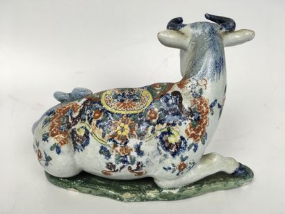 null DELFT (Kind of) Earthenware figurine representing a cow lying on a mound decorated...