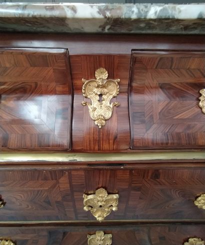 null A BRIDGE COMMODE in veneer and rosewood marquetry opening in front of four drawers...