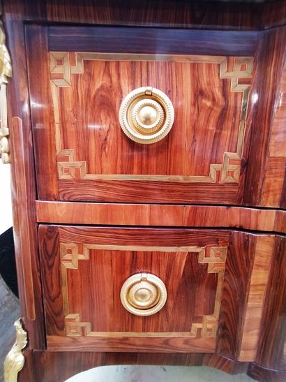 null A wood veneer and marquetry chest of drawers with two drawers in the front,...