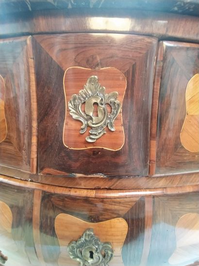 null A tomb-like chest of drawers made of veneer and marquetry with four drawers...