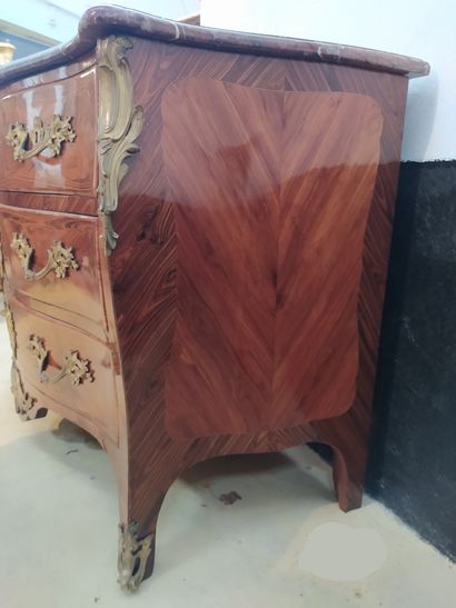 null A veneer and violet wood marquetry chest of drawers with four drawers on three...