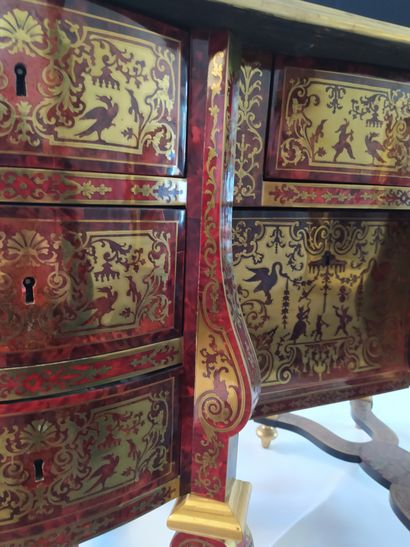 null A "mazarin" desk in red tinted tortoiseshell veneer and brass inlaid "in part"...