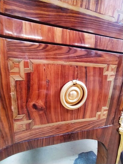 null A wood veneer and marquetry chest of drawers with two drawers in the front,...