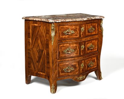 null A geometric marquetry and veneer chest of drawers with three drawers in three...