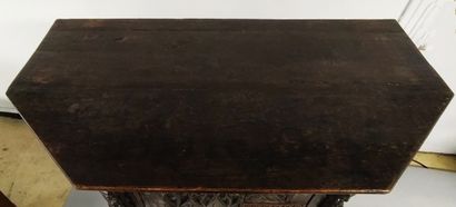 null A carved oak chest of drawers with a trapezoidal plan and arcatures decoration....