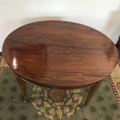null DINING ROOM TABLE 

in mahogany and mahogany veneer resting on six sheath feet...