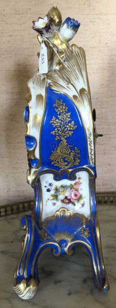 null A Parisian porcelain HANGER with bouquets of flowers on a blue and gold background....