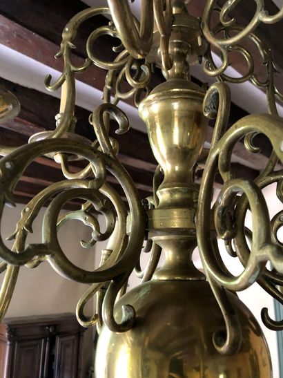 null A gilded brass chandelier with two rows of lights with six arms each. Baluster...