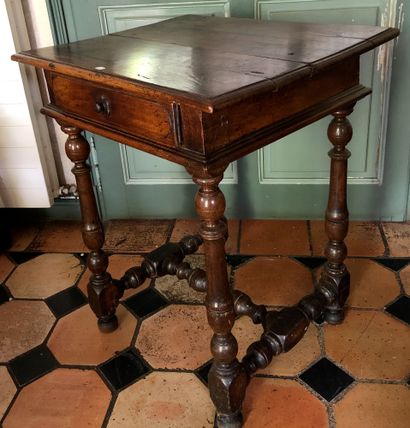 null WRITING TABLE in walnut turned, moulded and carved, opening with a drawer in...