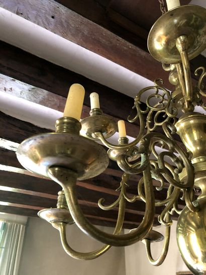 null A gilded brass chandelier with two rows of lights with six arms each. Baluster...