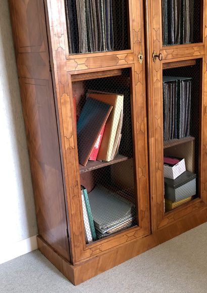 null Bookcase in cherry wood veneer on fir and amaranth net. 	 It opens to two doors...