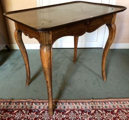 null CABARET TABLE with mahogany and guaiac top. 				 Opening with a drawer in the...