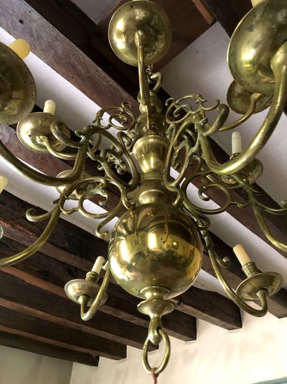 null A gilded brass chandelier with two rows of lights with six arms each. Baluster...