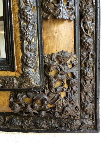 null MIRROR in stained wood with rich ornamentation of openwork, embossed and chased...