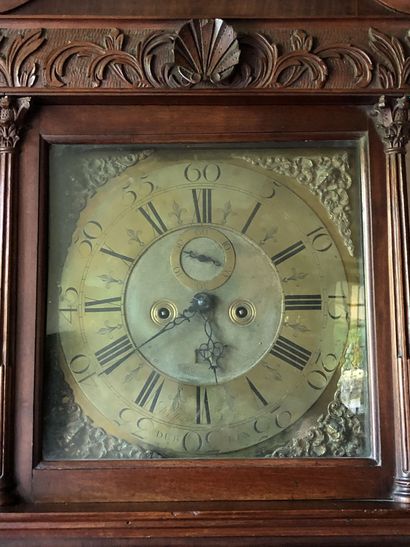 null A mahogany and mahogany veneer sheath clock with gusseted legs Signed William...