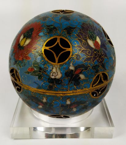  CHINA A gilt bronze and cloisonné openwork sphere, opening in its center and serving...