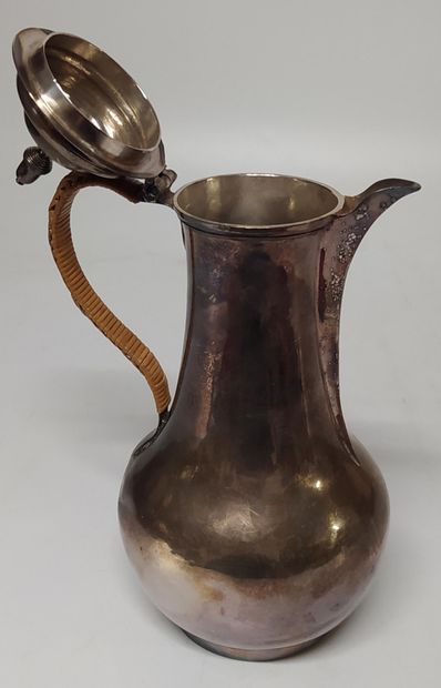 null A plain silver JUG, the body chased with a coat of arms, the handle in rope...
