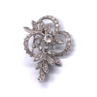  PINK holding a floral design adorned in its centre with an old cut diamond and in...