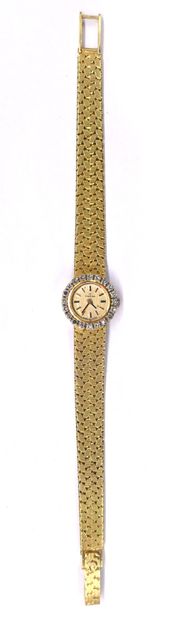 null 
OMEGA 

WATCH

in 18K yellow gold, round case, bezel paved with brilliant-cut...