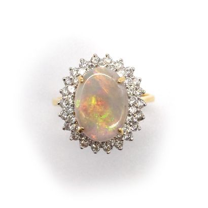 RING presenting a white opal in a double...