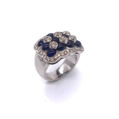 null RING holding three lines of sapphire cabochons punctuated with brilliant-cut...