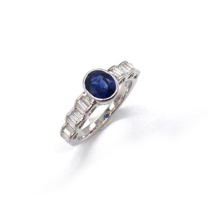 null RING in 18K white gold holding a sapphire in a baguette diamond setting on a...