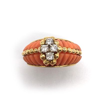 null RING holding coral gadroons, adorned with a line of gold beads, with four brilliant-cut...