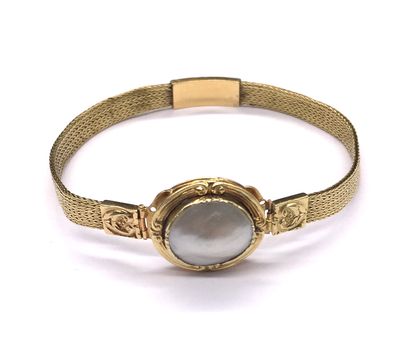 null BRACELET holding an oval white pearl encircled by a yellow gold frame with an...
