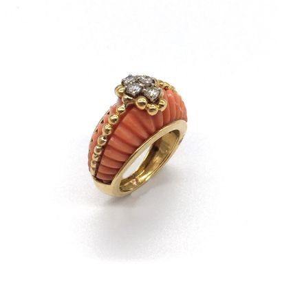 null RING holding coral gadroons, adorned with a line of gold beads, with four brilliant-cut...