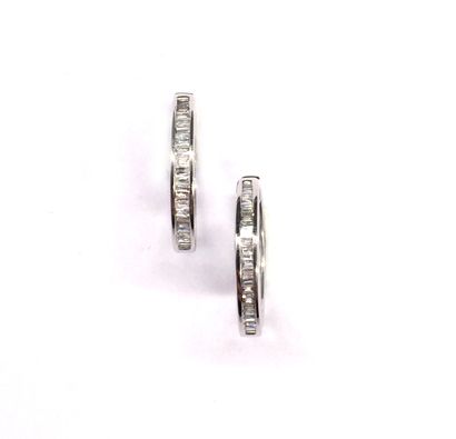  PAIR OF CREOLES holding a succession of baguette diamonds, set in 18K white gold....