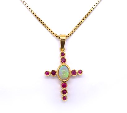 null 18K yellow gold PENDANT representing a cross adorned with a cabochon opal and...