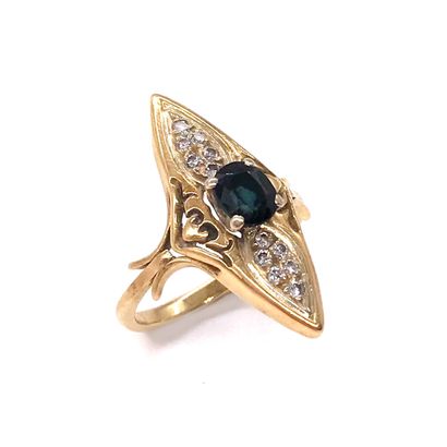 null 18K yellow gold ring presenting a shuttle shape holding a sapphire surrounded...
