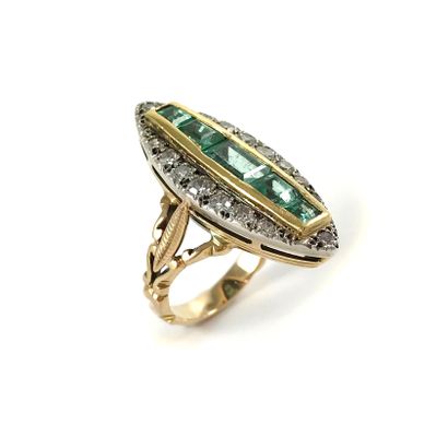 null RING in the form of a shuttle holding five calibrated emeralds in an 8/8 diamond...