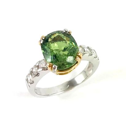 RING set with a 4.54 carat oval demantoid...