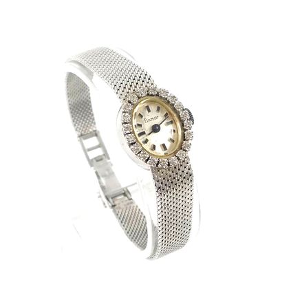 null 
WATCH
adorned with an oval dial holding a border of brilliant-cut diamonds....