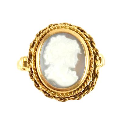 null RING with a cameo showing a woman in profile. Twisted chain setting in 18K yellow...