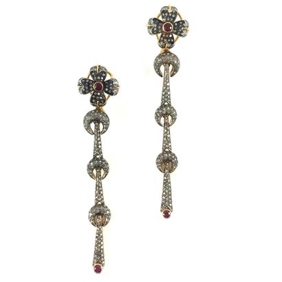 null PAIR OF EARRINGS with a flower holding three moons, continuing with drops. It...
