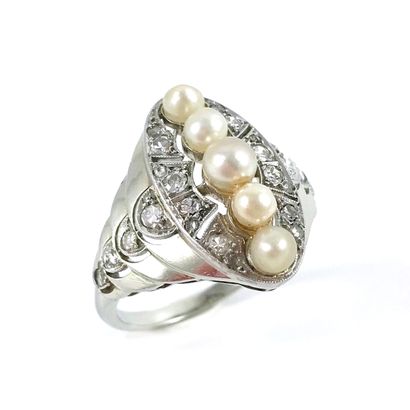 null RING holding an oval tray adorned with a line of probably fine white pearls...