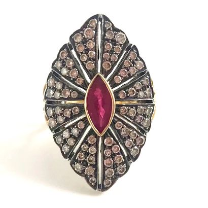 null A navette-shaped ring set with a navette ruby surrounded by brilliant-cut diamonds...