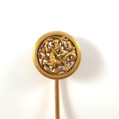 null SET OF TWO PINS (WIESE) - 18K yellow gold. This pin holds a drawing of an ichthyocentaur,...