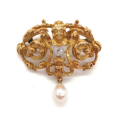 A 1900's era brooch with a face surrounded...