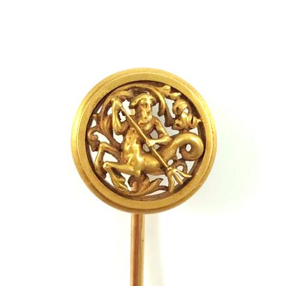 null SET OF TWO PINS (WIESE) - 18K yellow gold. This pin holds a drawing of an ichthyocentaur,...