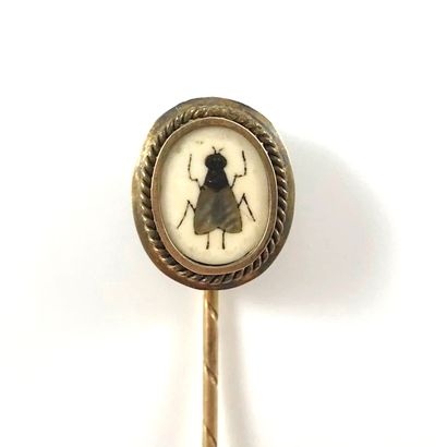 null SET OF TWO PINS (WIESE) - 18K yellow gold. This pin holds a drawing of an ichthyocentaur,...