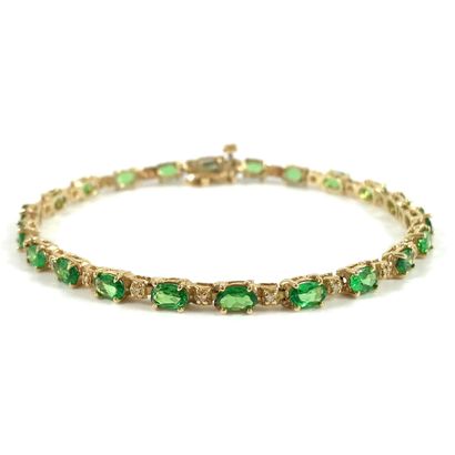 null LINE BRACELET holding oval tsavorites punctuated with brilliant-cut diamonds....