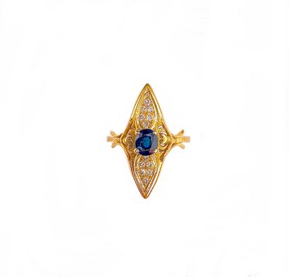 null 18K yellow gold ring presenting a shuttle shape holding a sapphire surrounded...