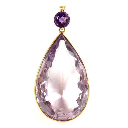 null A pear-shaped amethyst pendant of approximately 240 carats, held by a round...